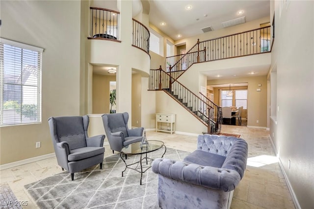 living room with a towering ceiling and a wealth of natural light