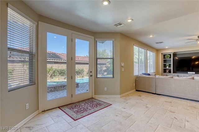 doorway featuring built in features and ceiling fan