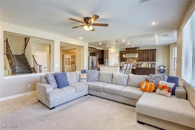 living room with light carpet and ceiling fan