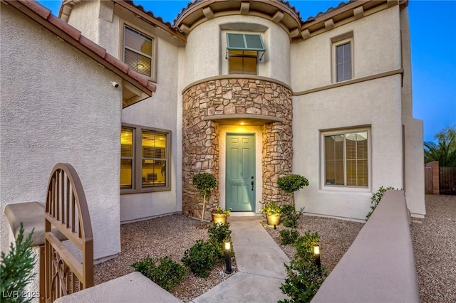 9950 Waxberry Ct, Las Vegas, NV 89178 - entrance to property with stone siding, stucco siding, a tiled roof, and fence