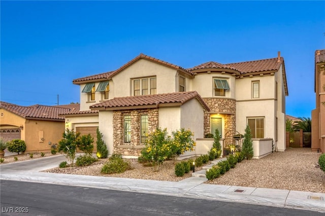9950 Waxberry Ct, Las Vegas, NV 89178 - mediterranean / spanish home featuring a garage, fence, stucco siding, and stone siding
