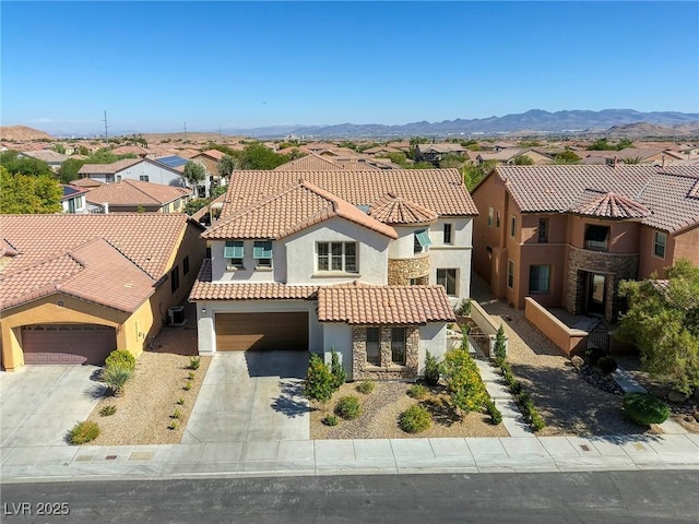 view of front of home with a garage and a mountain view