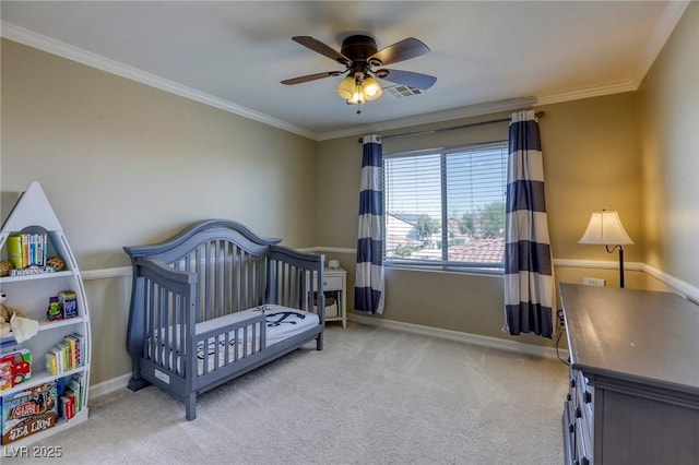 carpeted bedroom featuring crown molding, a nursery area, and ceiling fan