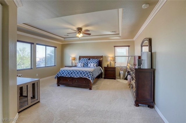 bedroom with multiple windows, ornamental molding, and a raised ceiling