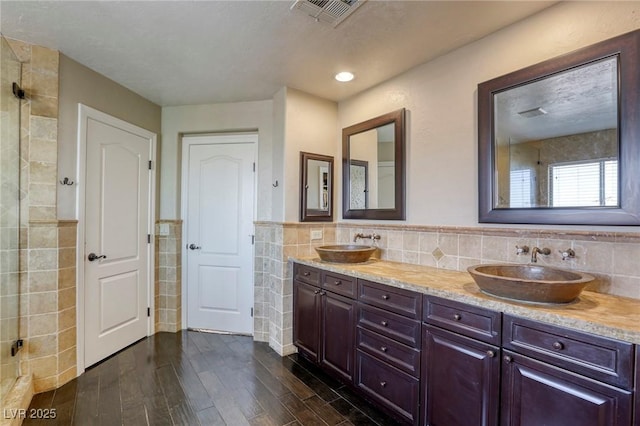 bathroom with tile walls, vanity, and hardwood / wood-style flooring