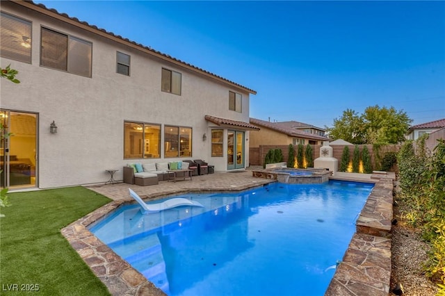 view of swimming pool with an in ground hot tub, an outdoor living space with a fireplace, a patio, and a lawn