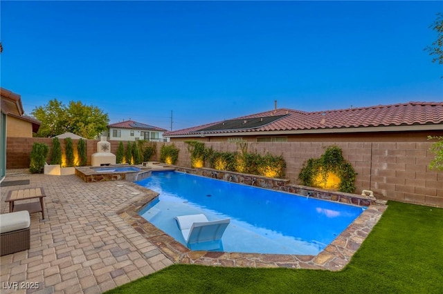 view of pool with an in ground hot tub, pool water feature, and a patio area