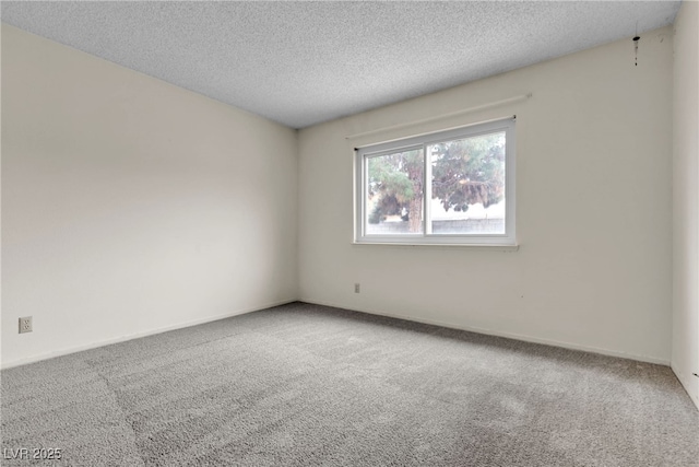 carpeted empty room with a textured ceiling