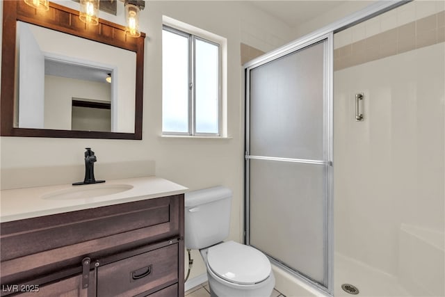 full bathroom with a stall shower, vanity, and toilet