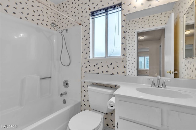 bathroom featuring shower / bathing tub combination, toilet, and wallpapered walls