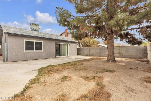 exterior space with cooling unit, a fenced backyard, a patio, and stucco siding