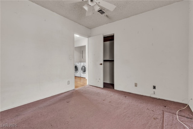 unfurnished bedroom with a textured ceiling, washing machine and dryer, visible vents, a closet, and carpet