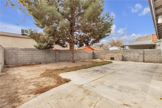 view of yard with a fenced backyard and a patio