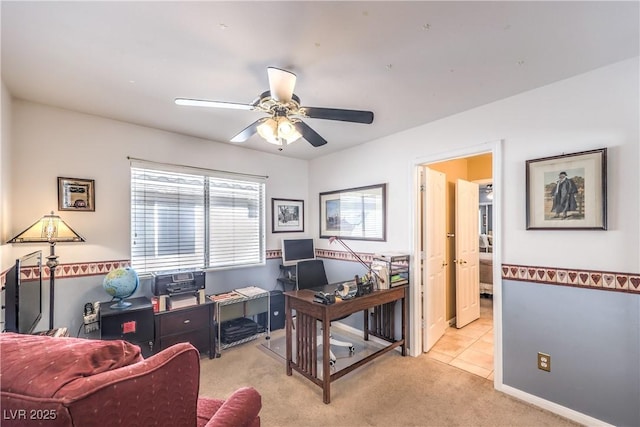 home office with light carpet, ceiling fan, and baseboards