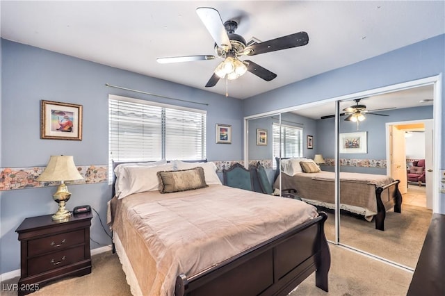 bedroom with ceiling fan, baseboards, a closet, and light colored carpet