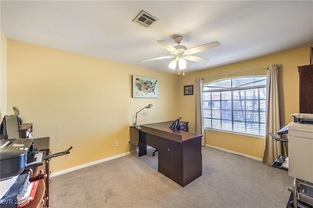 home office featuring light carpet, baseboards, visible vents, and a ceiling fan