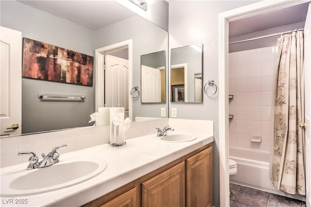 full bath with shower / tub combo with curtain, a sink, toilet, and tile patterned floors