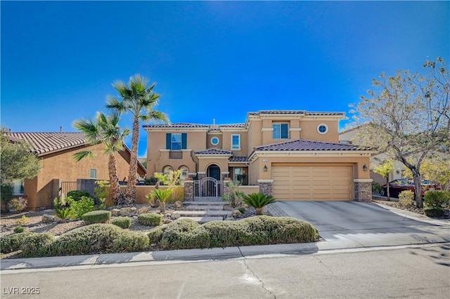 mediterranean / spanish-style house featuring stucco siding, a gate, stone siding, driveway, and a tiled roof