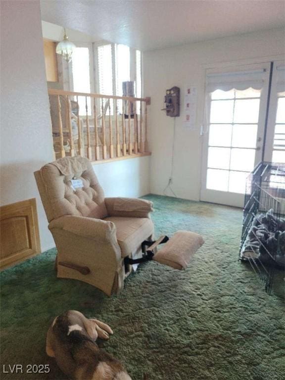 living area featuring carpet floors and a notable chandelier