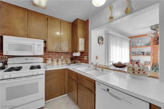 kitchen with sink, decorative backsplash, white appliances, and ceiling fan