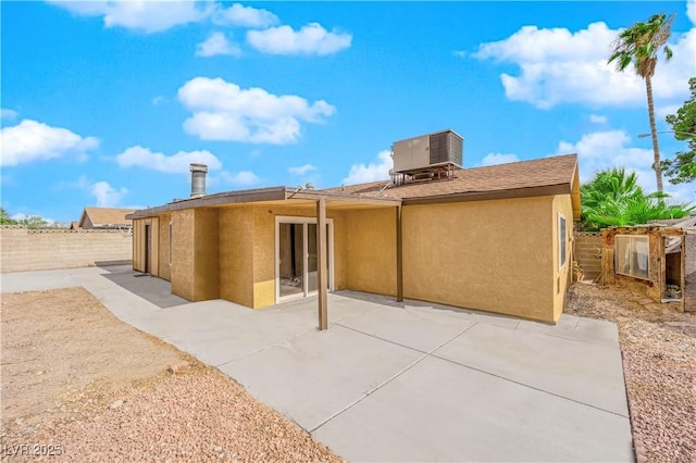 rear view of property featuring a patio area and central air condition unit