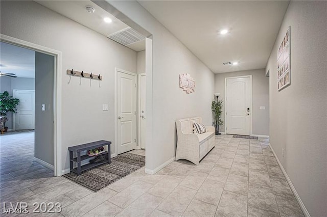 hall with recessed lighting, visible vents, and baseboards