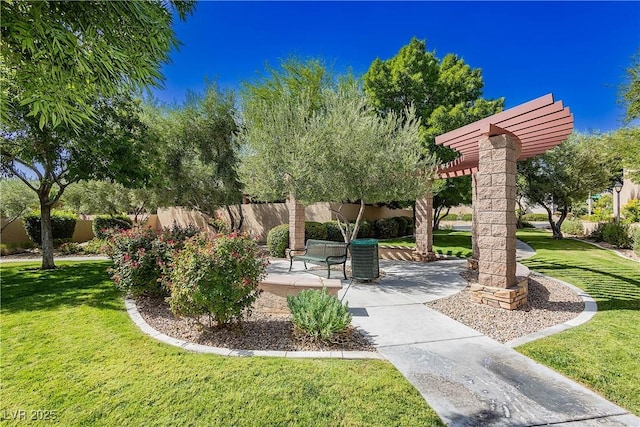 view of property's community with a pergola, a yard, and a patio area