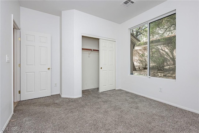 unfurnished bedroom featuring carpet flooring and a closet