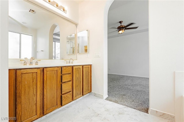 bathroom with ceiling fan and vanity