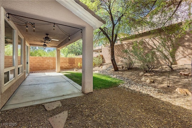 view of yard featuring a patio and ceiling fan