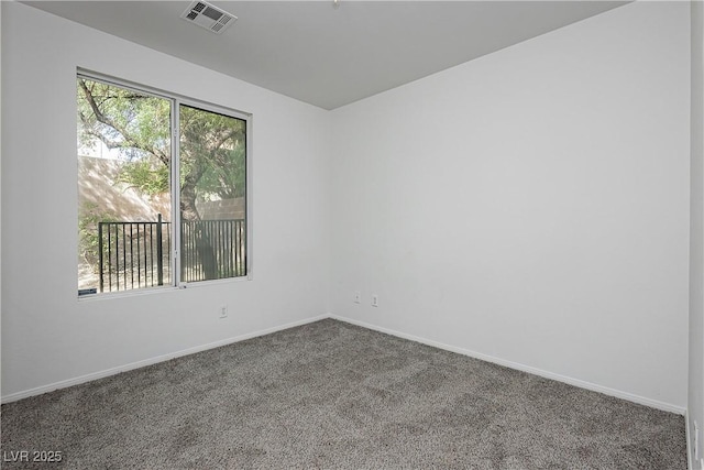 empty room featuring baseboards, carpet, and visible vents