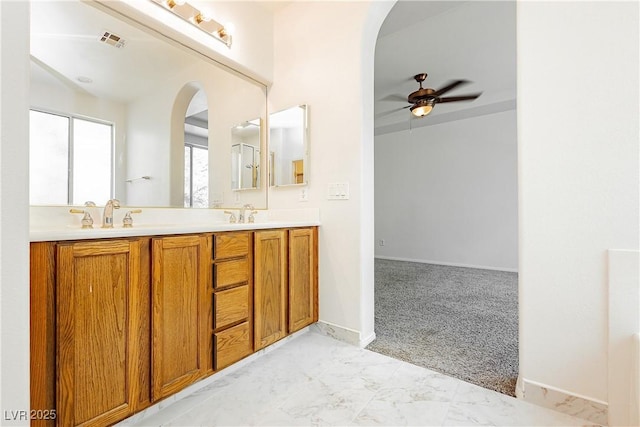 bathroom featuring double vanity, a ceiling fan, visible vents, marble finish floor, and a sink