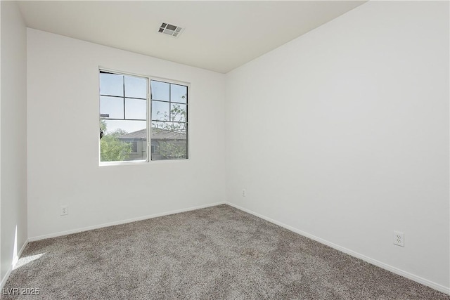 empty room with visible vents, baseboards, and carpet flooring