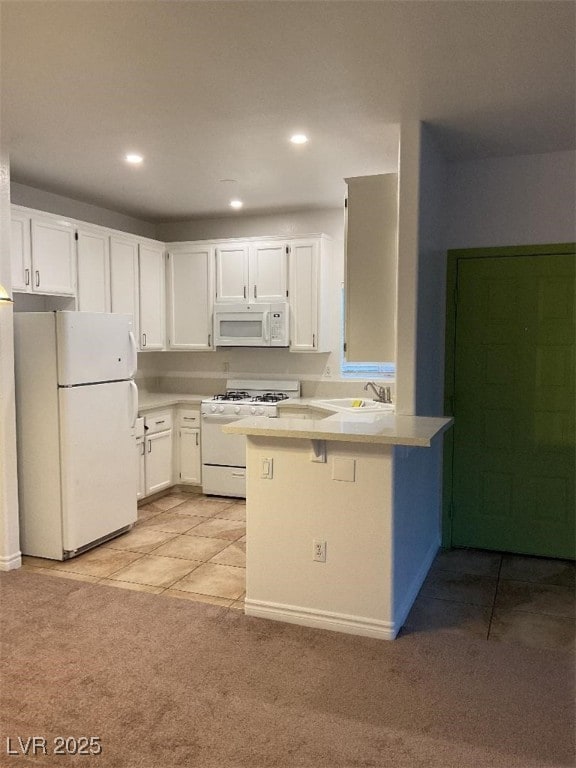 75 N Valle Verde Dr Unit 621, Henderson, NV 89074 - kitchen featuring white appliances, a peninsula, light colored carpet, white cabinetry, and a sink