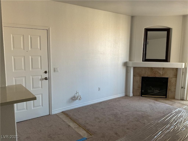 75 N Valle Verde Dr Unit 621, Henderson, NV 89074 - unfurnished living room featuring a fireplace, baseboards, tile patterned flooring, and carpet flooring