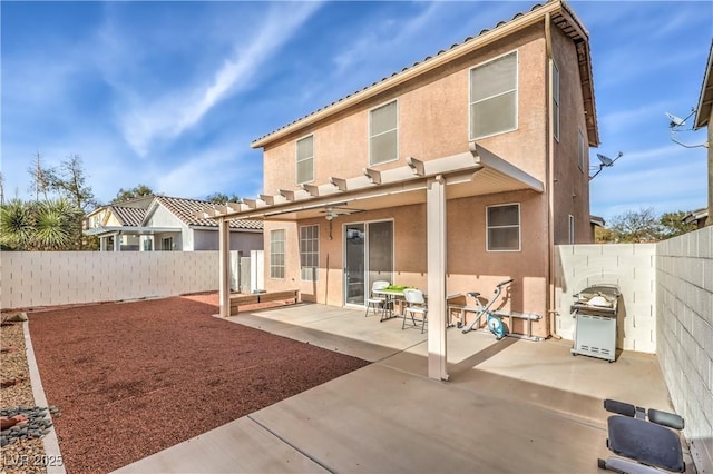 rear view of property with a patio area and ceiling fan