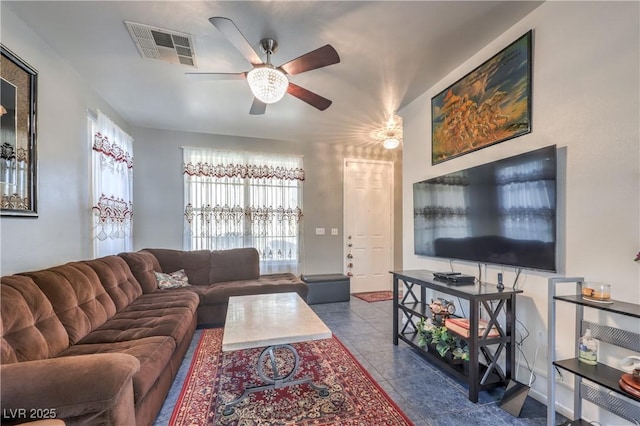 living room with ceiling fan and light tile patterned flooring