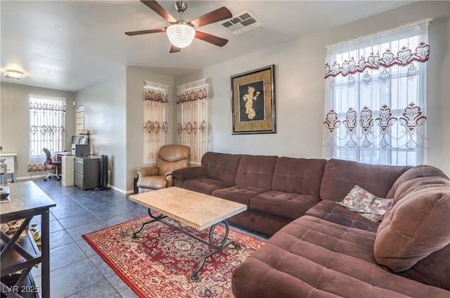 tiled living room with a healthy amount of sunlight and ceiling fan