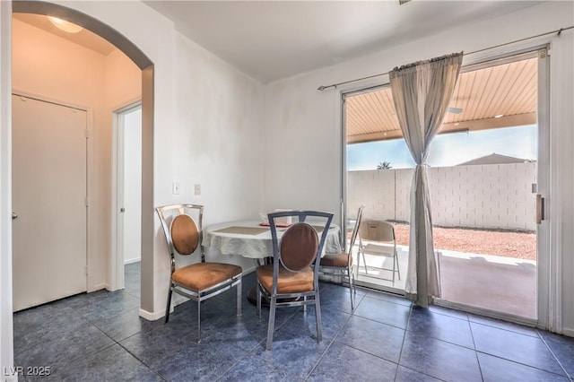 dining area featuring dark tile patterned floors