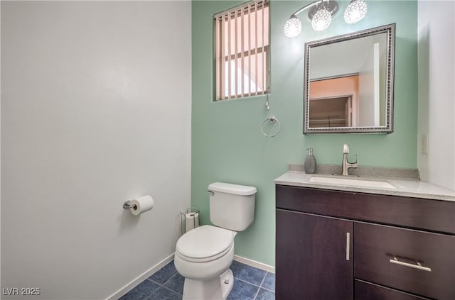 bathroom with vanity, tile patterned floors, and toilet