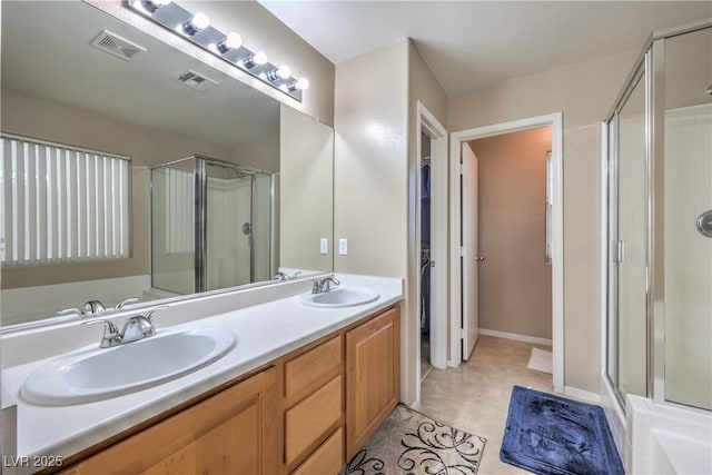 bathroom featuring an enclosed shower, vanity, and tile patterned floors