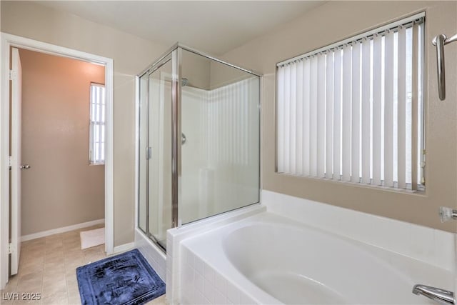 bathroom with tile patterned floors and independent shower and bath