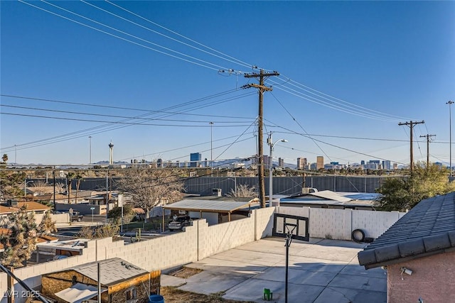 exterior space featuring a view of city and fence