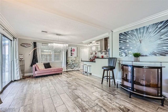 interior space featuring ornamental molding, wood tiled floor, baseboards, and an inviting chandelier