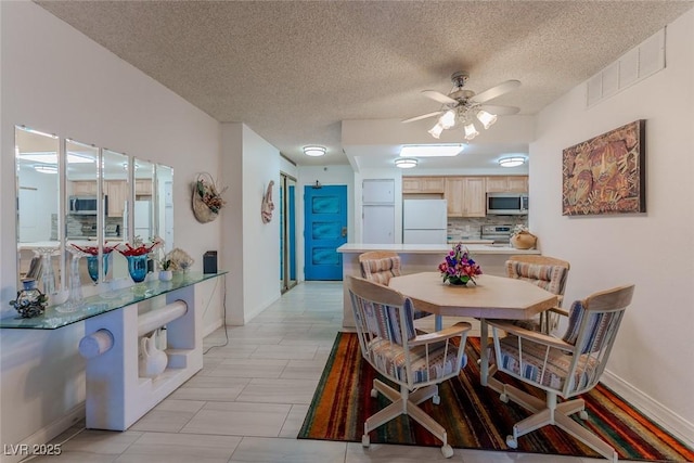 dining space featuring a textured ceiling and ceiling fan