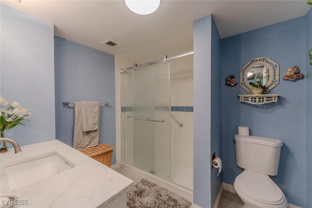 bathroom featuring toilet, vanity, and walk in shower