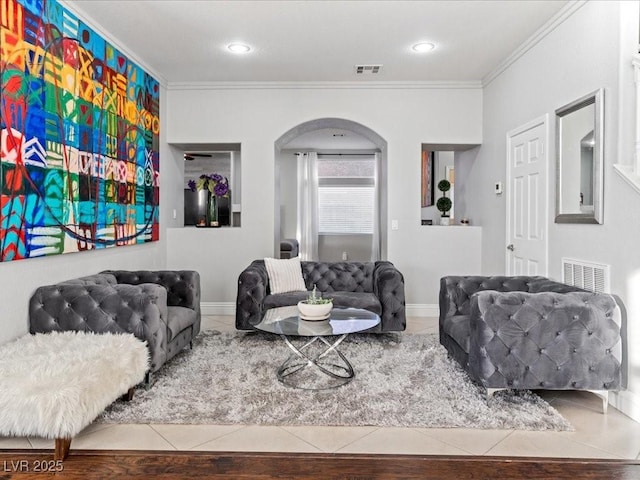 living room with tile patterned flooring and crown molding