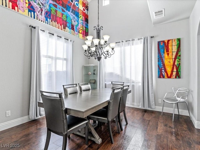 dining space featuring a chandelier and dark hardwood / wood-style flooring