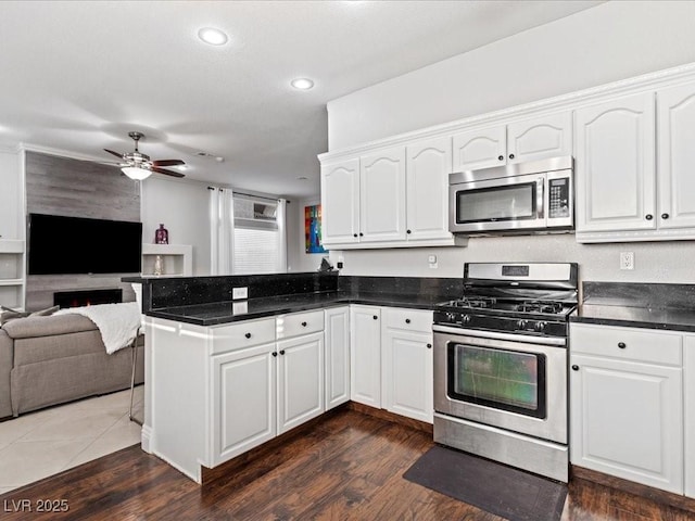 kitchen with appliances with stainless steel finishes and white cabinets