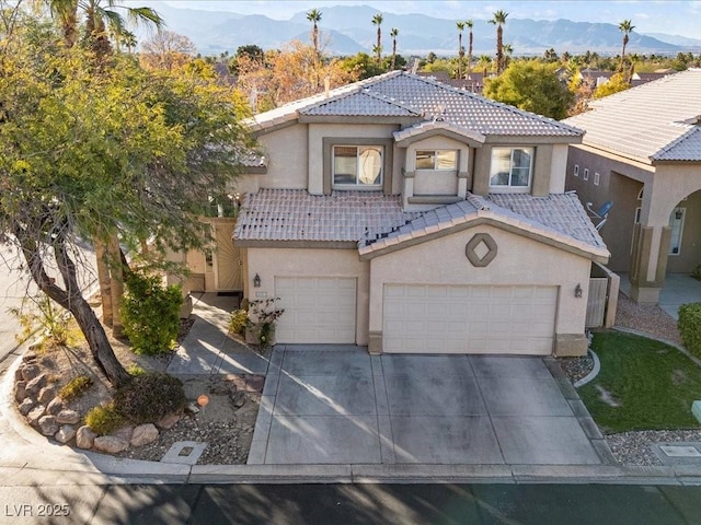 mediterranean / spanish-style house featuring a garage and a mountain view